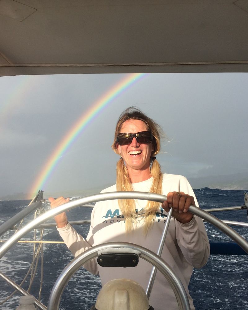 Captain Kerstin at the helm under a rainbow
